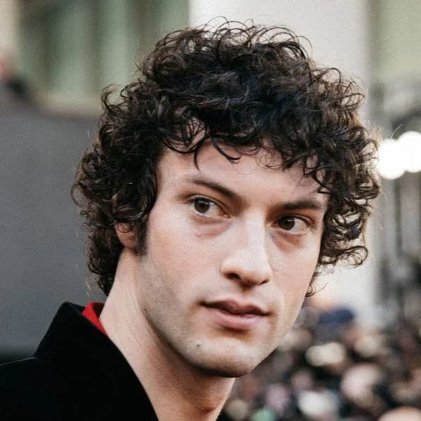 Messy Curly Mop Top hairstyle for oval face shape - men's medium curly hair