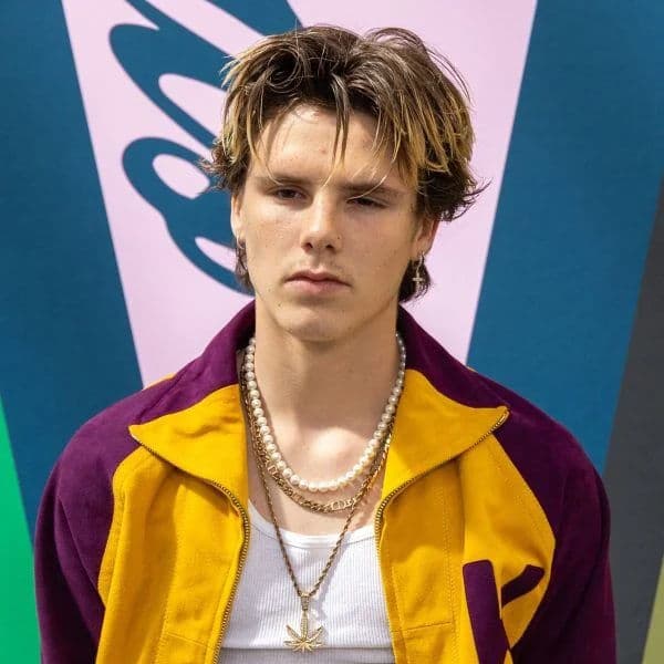 Textured Curtain Cut hairstyle for oval face shape - men's medium wavy hair