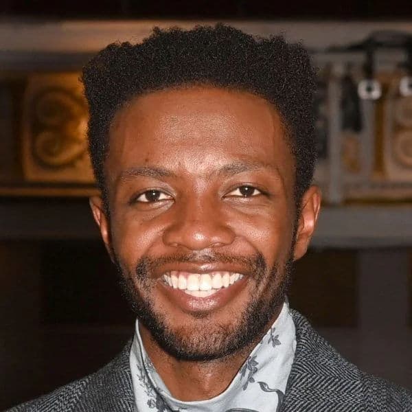 Textured High Top Fade hairstyle for oval face shape - men's short coily hair