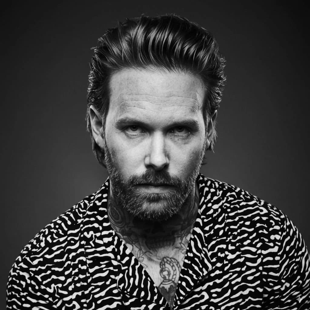 Textured Slick Back hairstyle for diamond face shape - men's medium straight hair