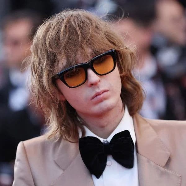 Textured Shag Wolf Cut hairstyle for oval face shape - men's medium-long wavy hair